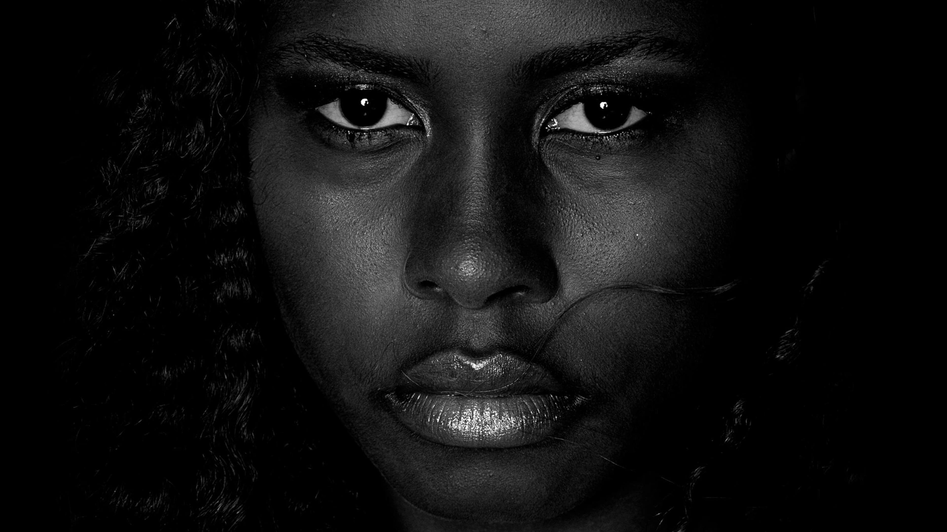 Black and white close-up of a woman looking directly at the camera