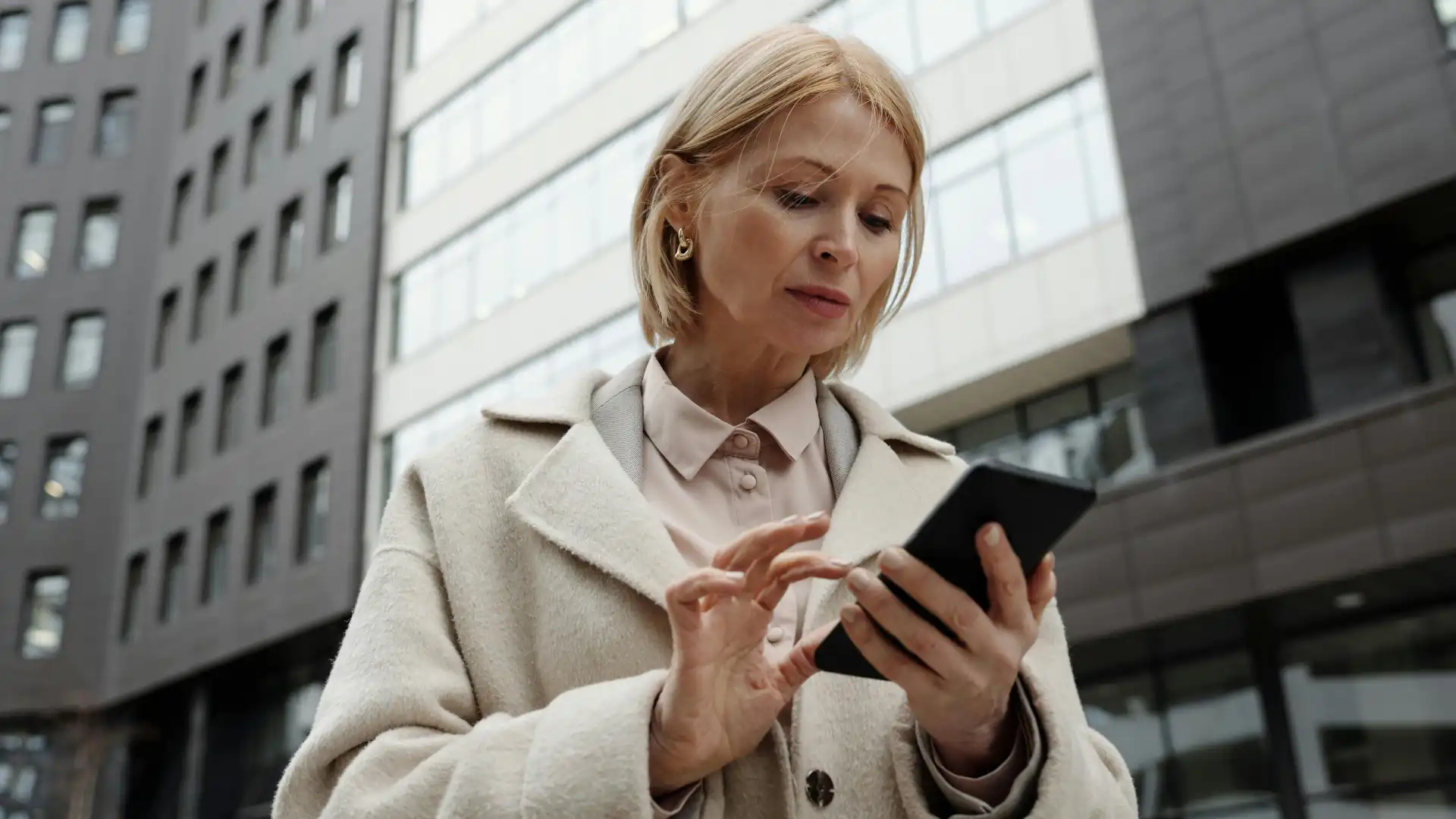 Woman in a jacket looking at her phone